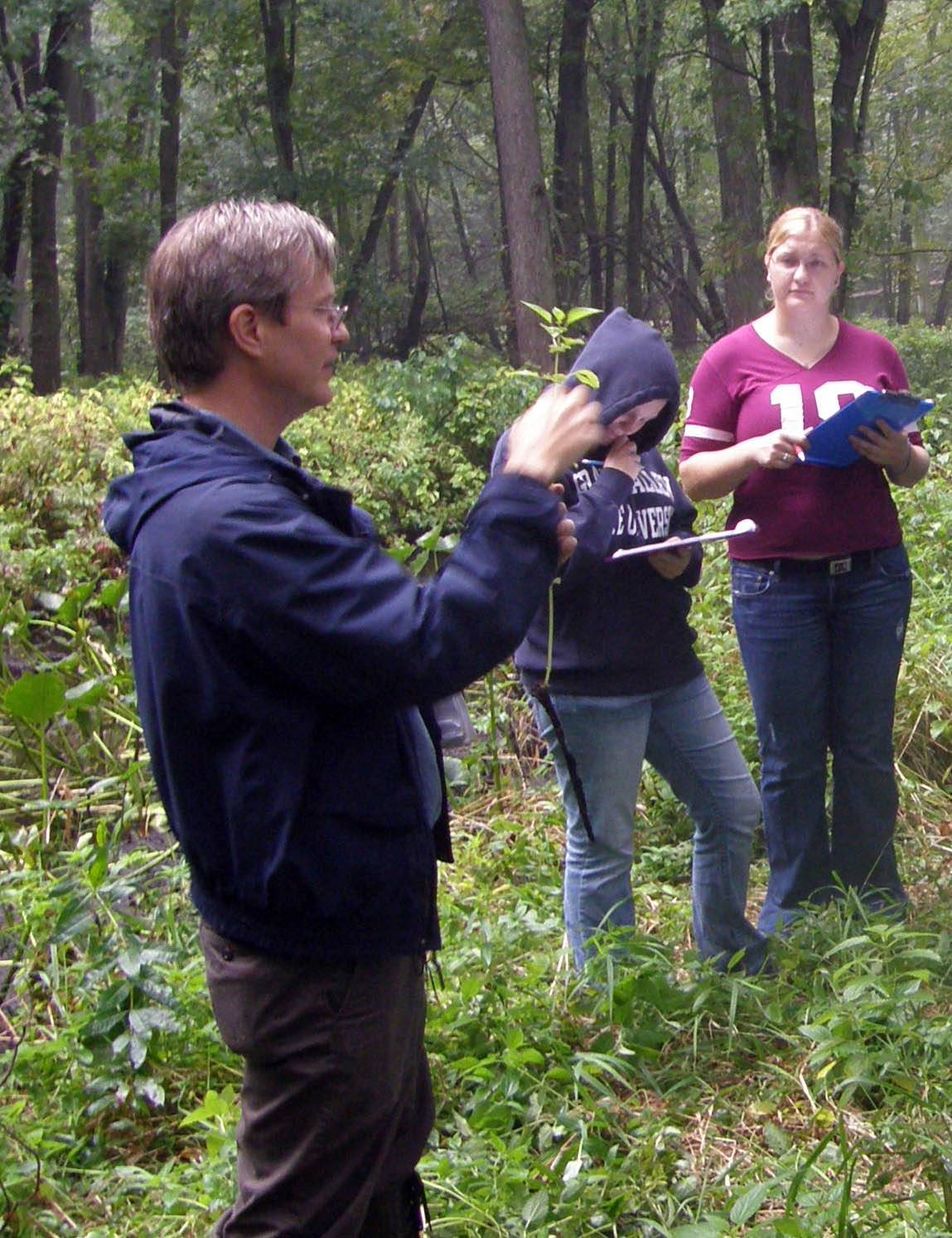 Bob Hollister and students identifying plants